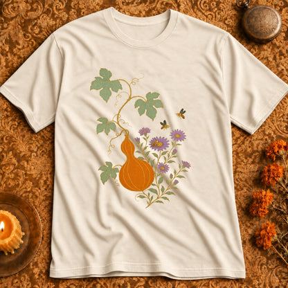 Cream t-shirt with an orange gourd, purple flowers, and bees design.
