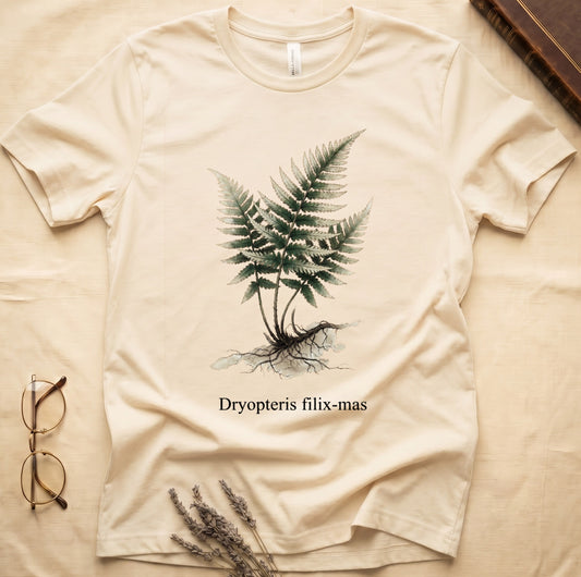 Natural tee with Victorian fern illustration of Dryopteris filix-mas in greens with exposed root, italic Latin binomial below.