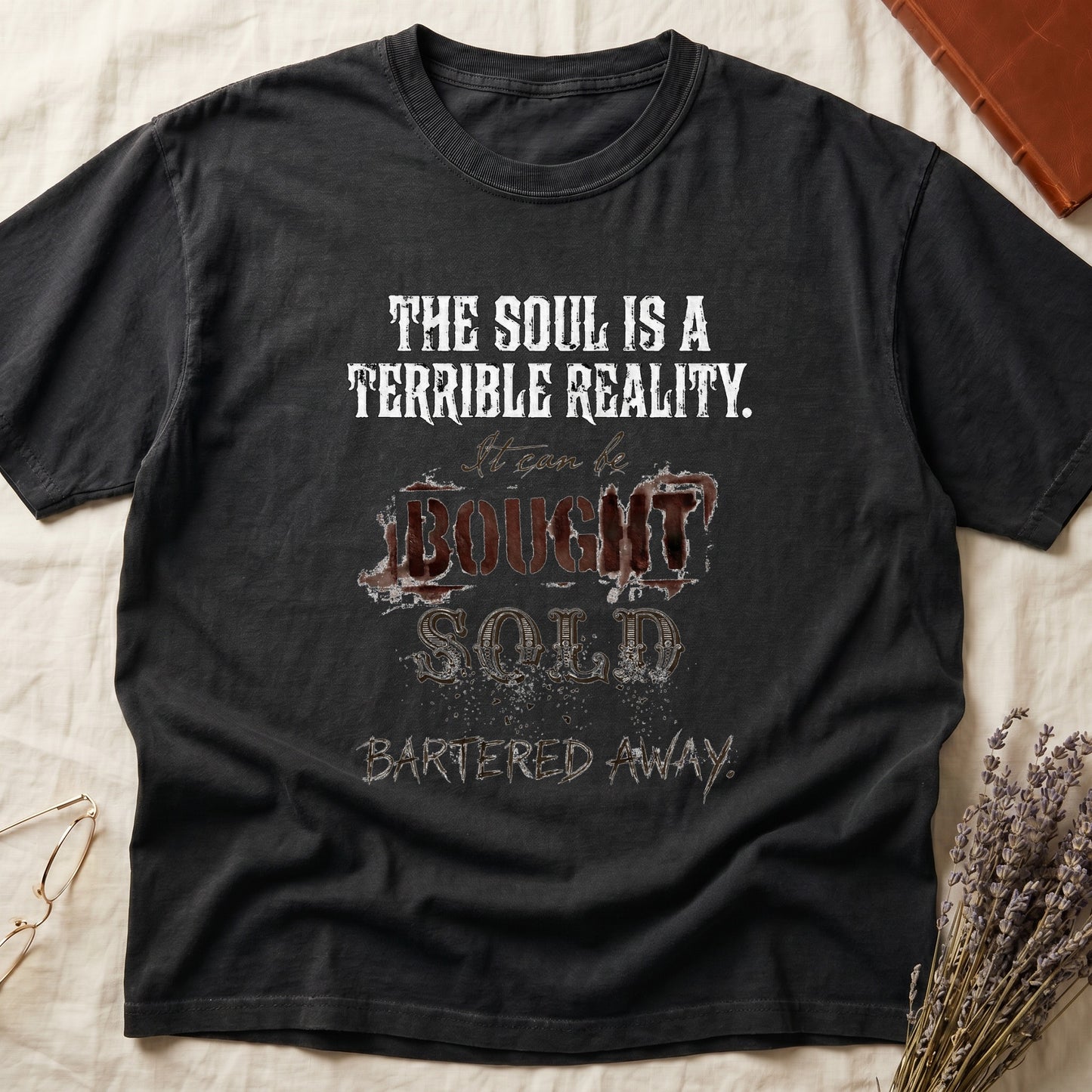 Black tee with distressed western type, "THE SOUL IS A TERRIBLE REALITY. It can be BOUGHT SOLD BARTERED AWAY."