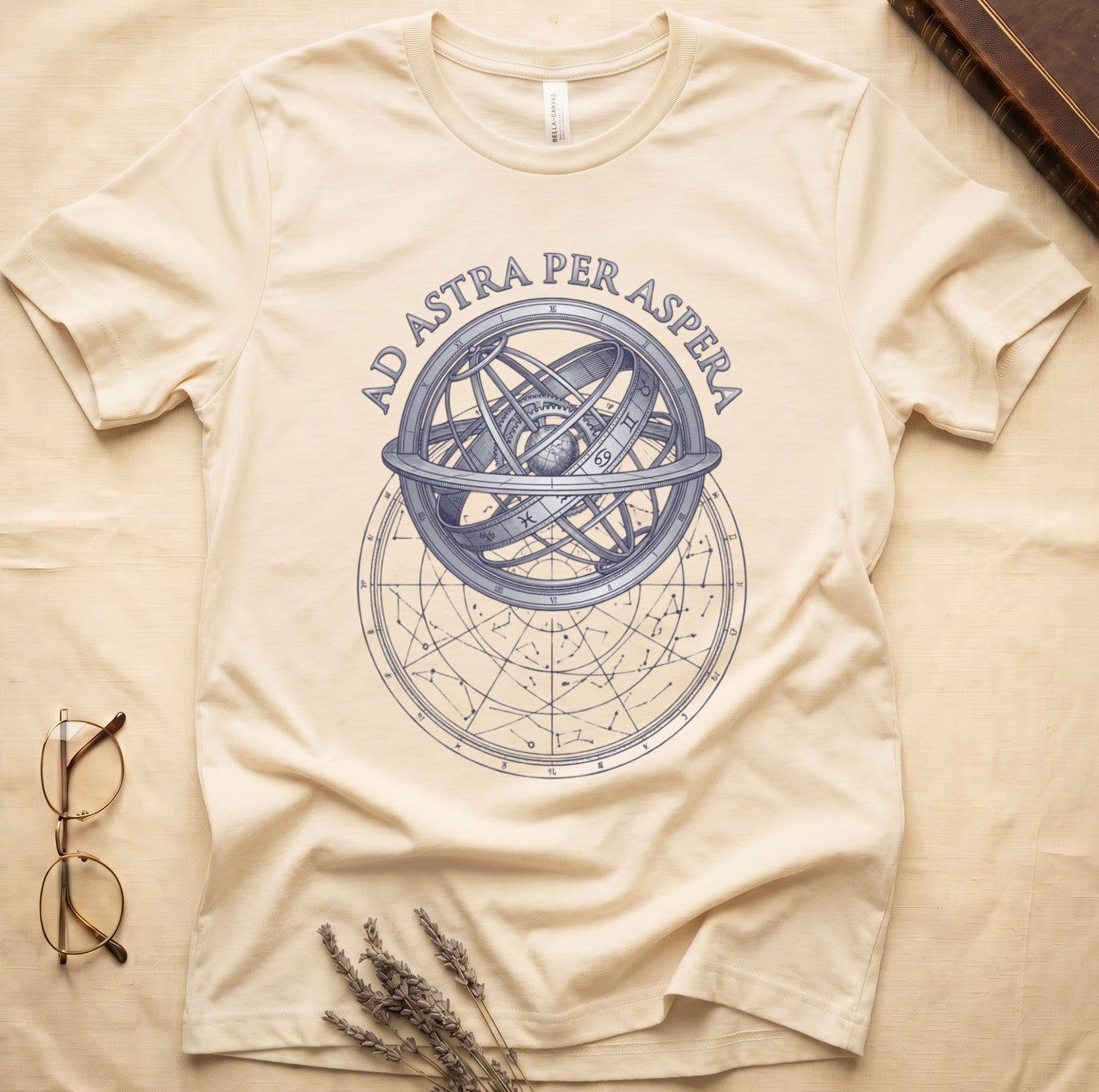 Natural tee with engraved armillary sphere, "AD ASTRA PER ASPERA" in serif capitals, zodiac symbols, classical astronomy.