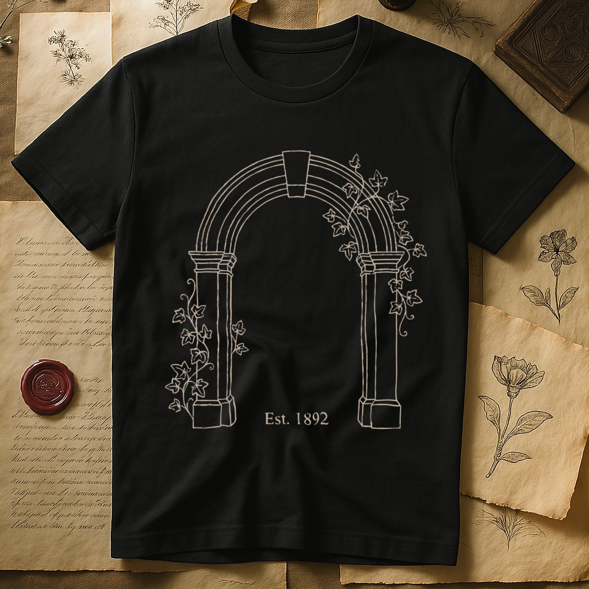 Black tee with Gothic stone archway in cream linework, ivy climbing the columns, "Est. 1892" inscribed at the base.