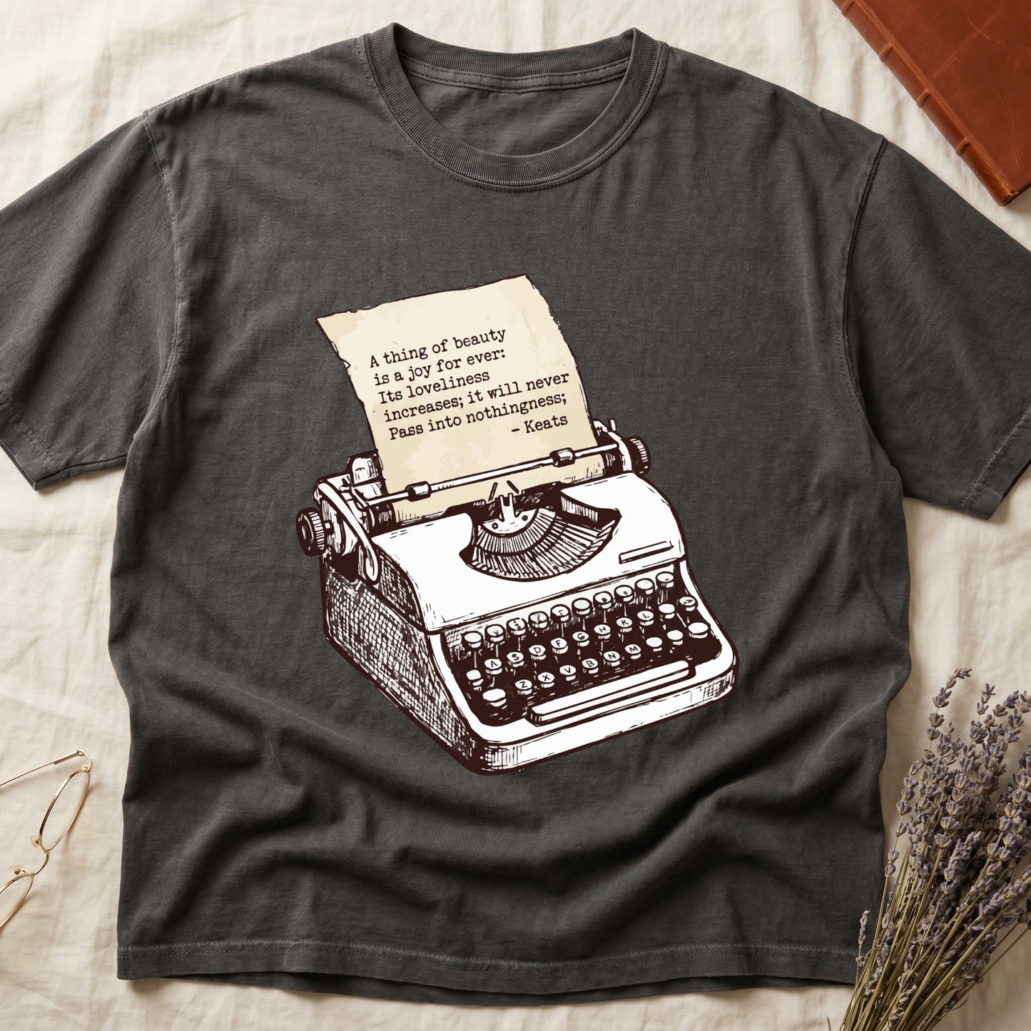 Pepper tee with vintage typewriter in cream linework, paper showing "A thing of beauty is a joy for ever" by Keats.
