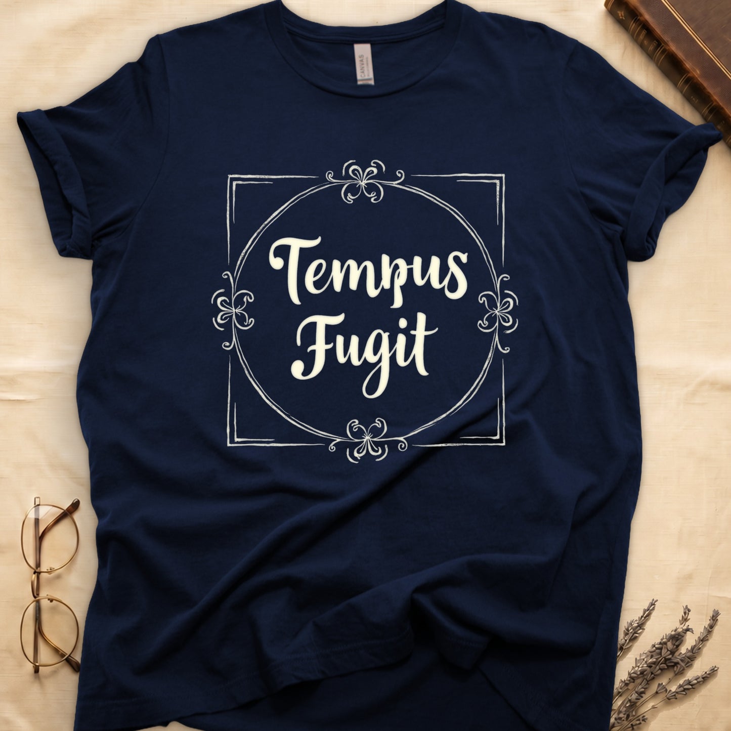 Navy tee with cream "Tempus Fugit" script inside square filigree frame, decorative corner flourishes, classical typography.
