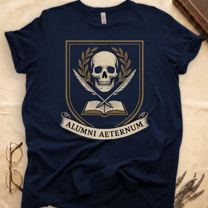 Navy tee with heraldic shield, skull and gold laurels, crossed quills, open book, scroll "ALUMNI AETERNUM" below.