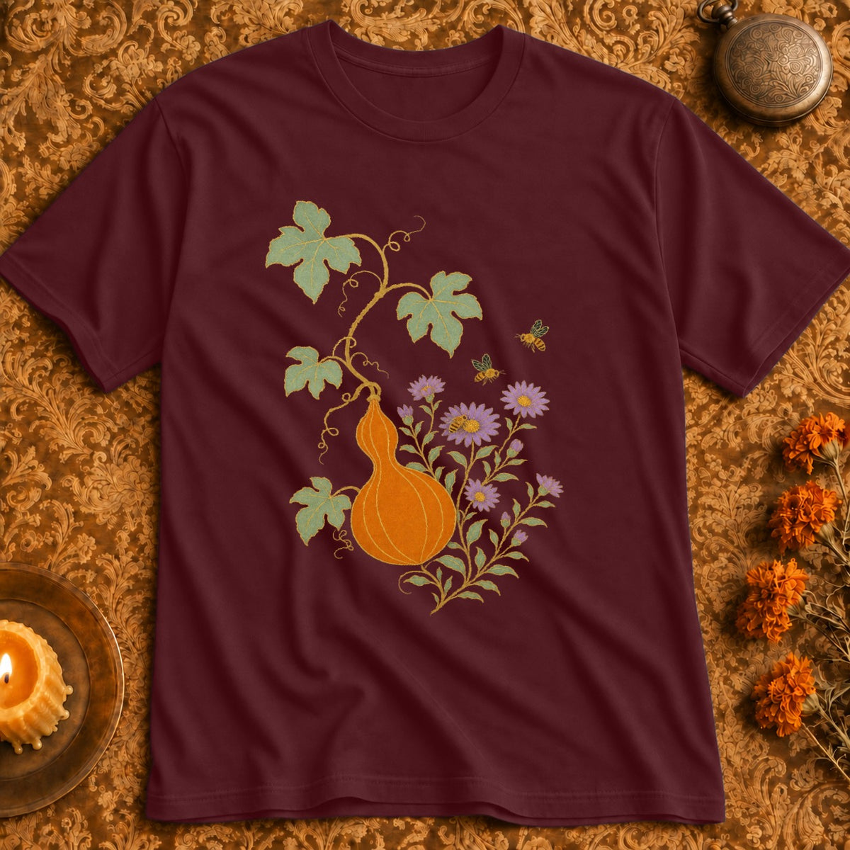 Maroon t-shirt with a gourd, flowers, and bees design.