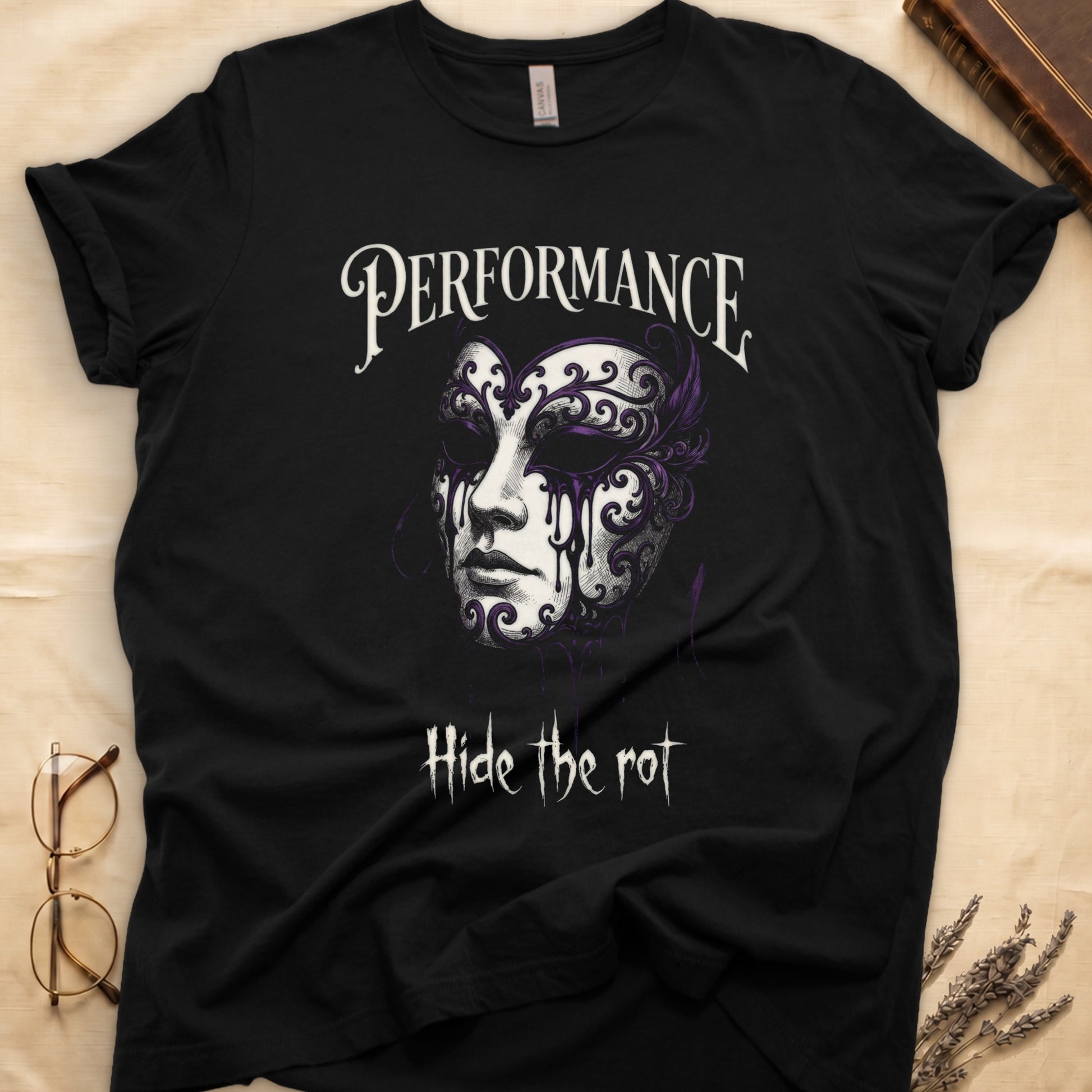 Black tee with ornate Venetian mask in cream and purple filigree dripping ink, "PERFORMANCE" top, "Hide the rot" below.