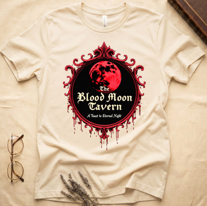 Natural tee with red oval frame, blood-red moon, "The Blood Moon Tavern," "A Toast to Eternal Night," red drips below.