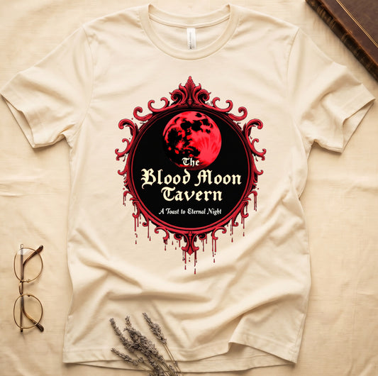 Natural tee with red oval frame, blood-red moon, "The Blood Moon Tavern," "A Toast to Eternal Night," red drips below.