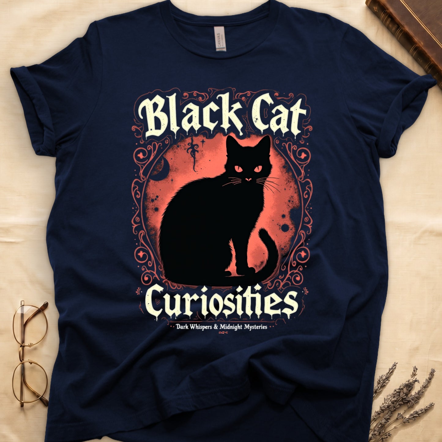 Navy tee with black cat, red eyes, red-orange moon, "Black Cat Curiosities," "Dark Whispers & Midnight Mysteries."
