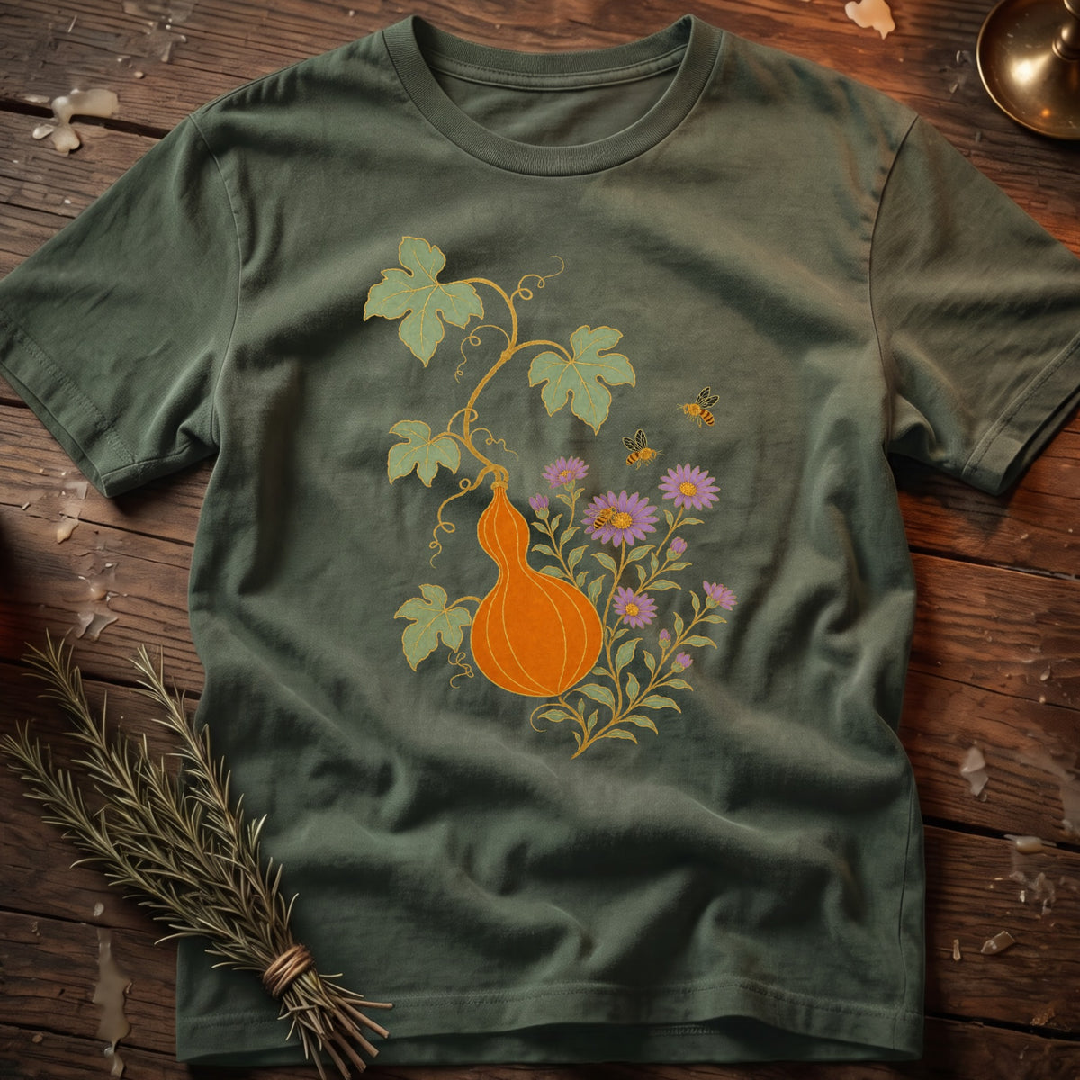 Green t-shirt with orange gourd, purple flowers, leaves, and bees illustration.