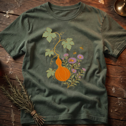 Green t-shirt with orange gourd, purple flowers, leaves, and bees illustration.