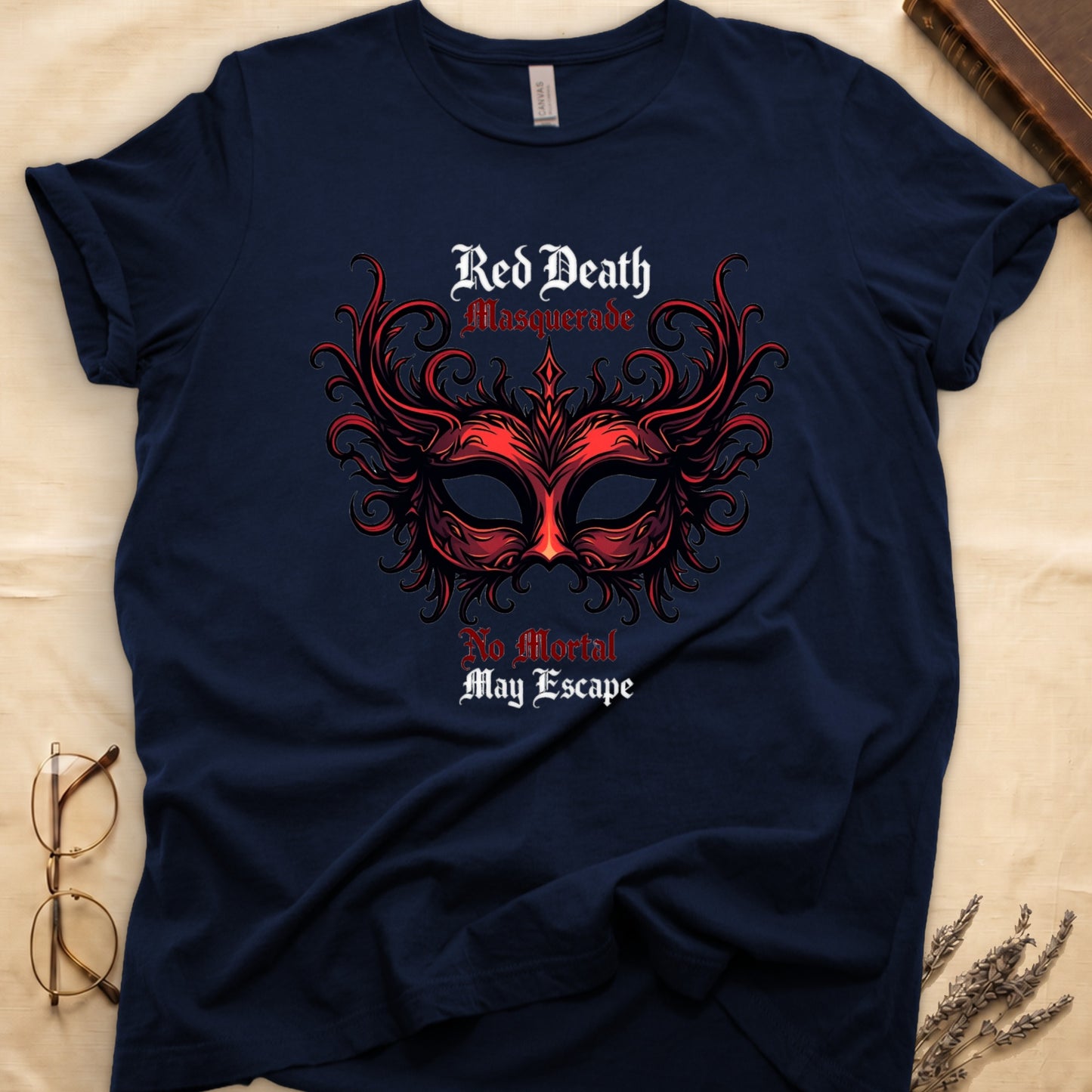 Navy tee with ornate red masquerade mask, flame scrollwork, "Red Death Masquerade" top, "No Mortal May Escape" below.
