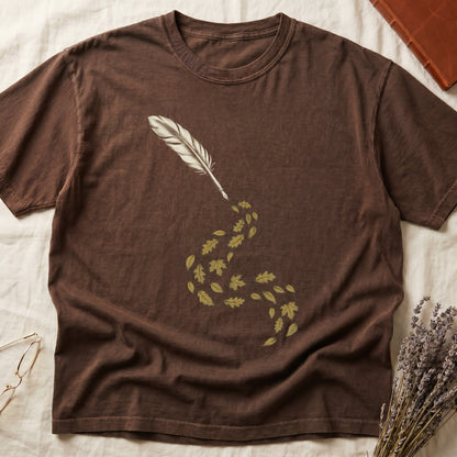 Espresso tee with antique quill pen in cream linework, oak and maple leaves cascading from the nib in gold and green.