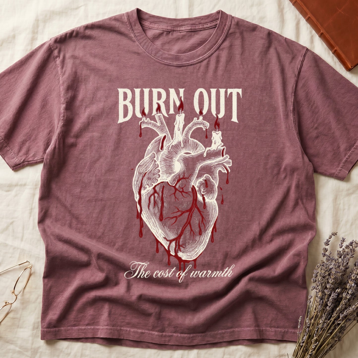 Dark Rose tee with anatomical heart and melted candles dripping red wax, "BURN OUT" top, "The cost of warmth" cursive below.