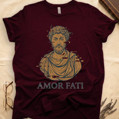 Maroon tee with bearded Stoic bust portrait in copper and slate, "AMOR FATI" in distressed serif capitals below.