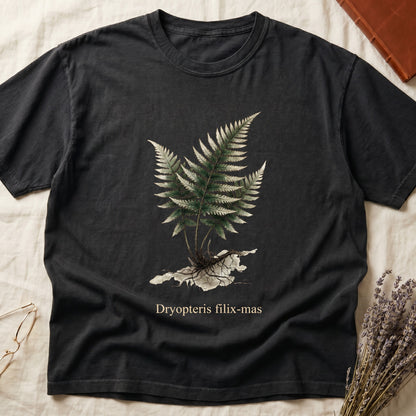 Black tee with Victorian fern illustration of Dryopteris filix-mas in greens with exposed root, italic Latin binomial below.
