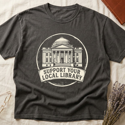 Pepper tee with circular cream badge of a classical library building, "SUPPORT YOUR LOCAL LIBRARY" on a banner below.