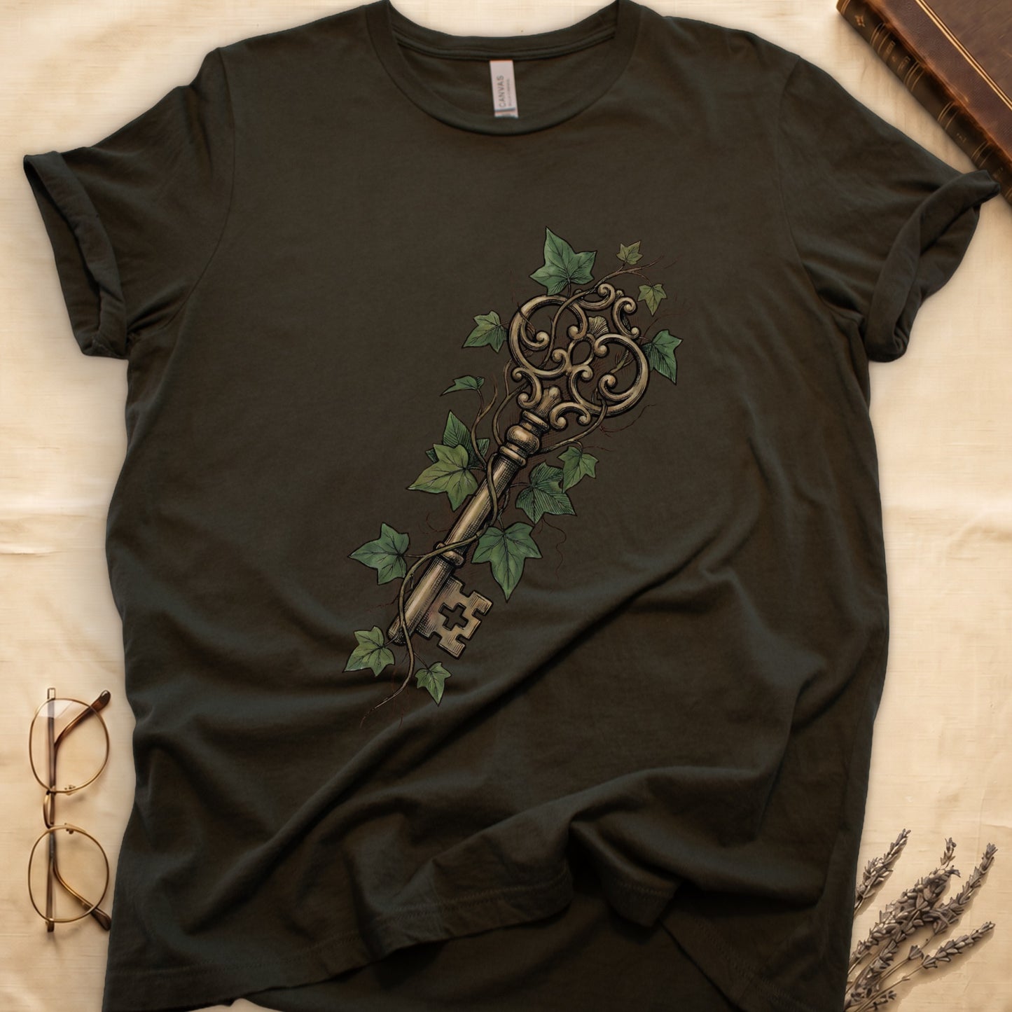 Military Green tee with ornate antique skeleton key in bronze, climbing English ivy in green on terracotta ground.