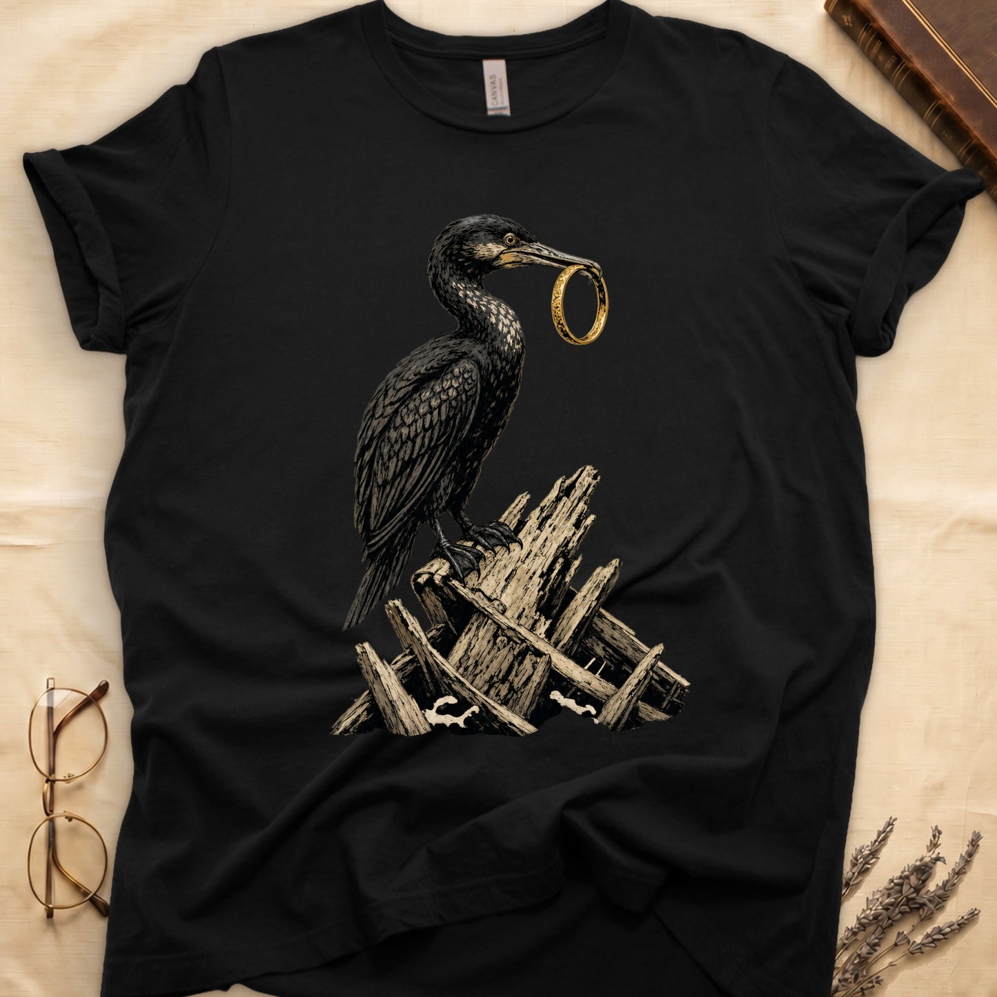 Black t-shirt with a cormorant holding a gold ring in its beak.
