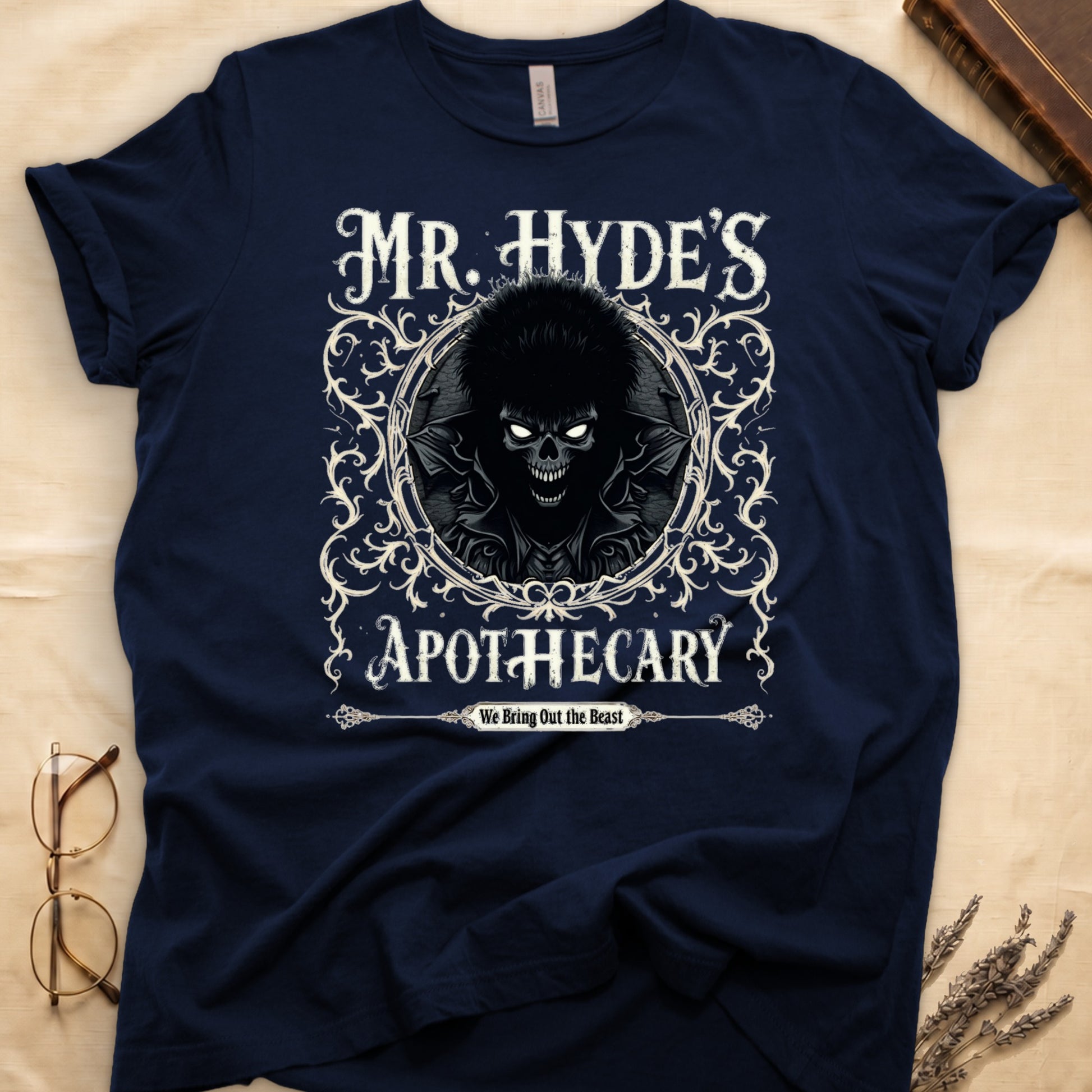 Black tee with ornate filigree frame, wild-haired skull figure, "MR. HYDE'S APOTECARY," "We Bring Out the Beast" below.