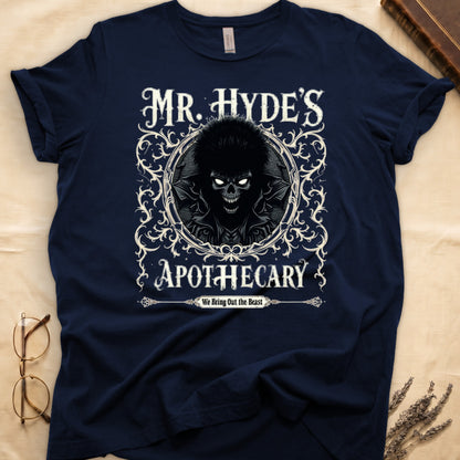 Black tee with ornate filigree frame, wild-haired skull figure, "MR. HYDE'S APOTECARY," "We Bring Out the Beast" below.