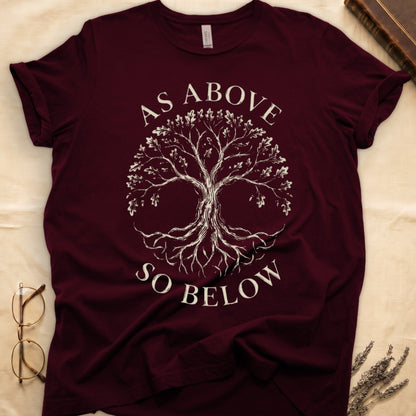 Maroon tee with Tree of Life in cream linework, mirrored canopy and roots, "AS ABOVE" and "SO BELOW" in serif arcs.