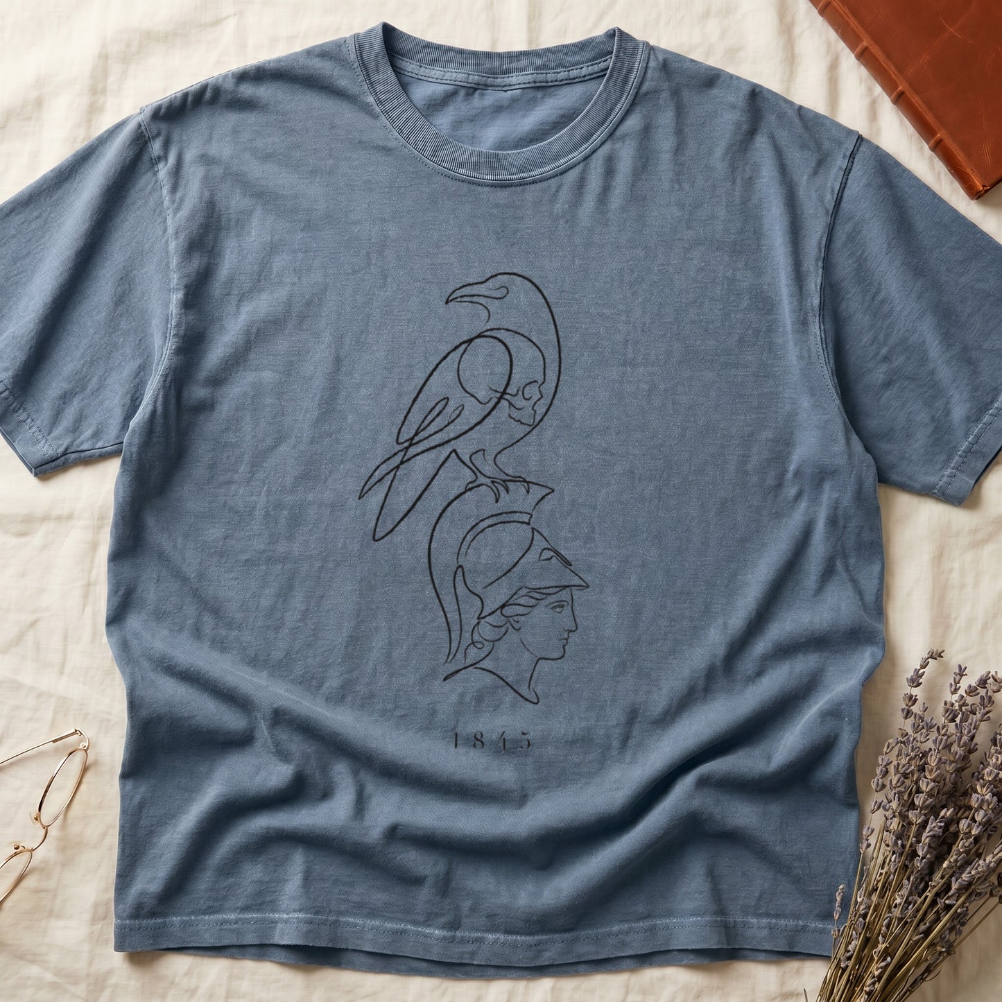Blue t-shirt with line art of a raven above a Greek helmet and the number 1845.