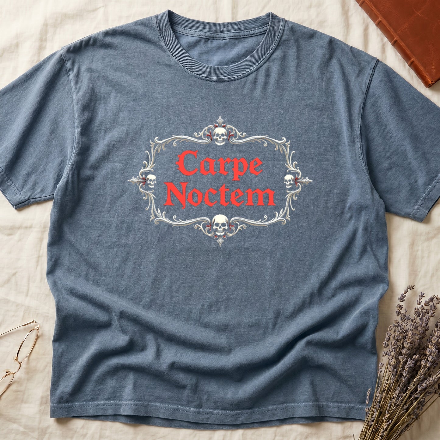 Blue Jean tee with silver filigree cartouche, crowned skull top and skull below, "Carpe Noctem" in deep-red blackletter inside.
