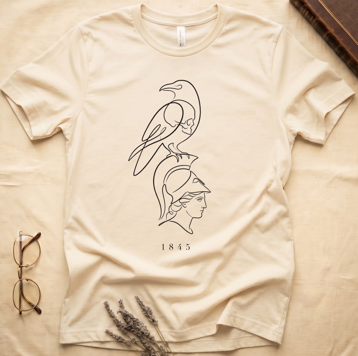 Cream t-shirt with black line art of a bird above a profile of a helmeted head and "1845".