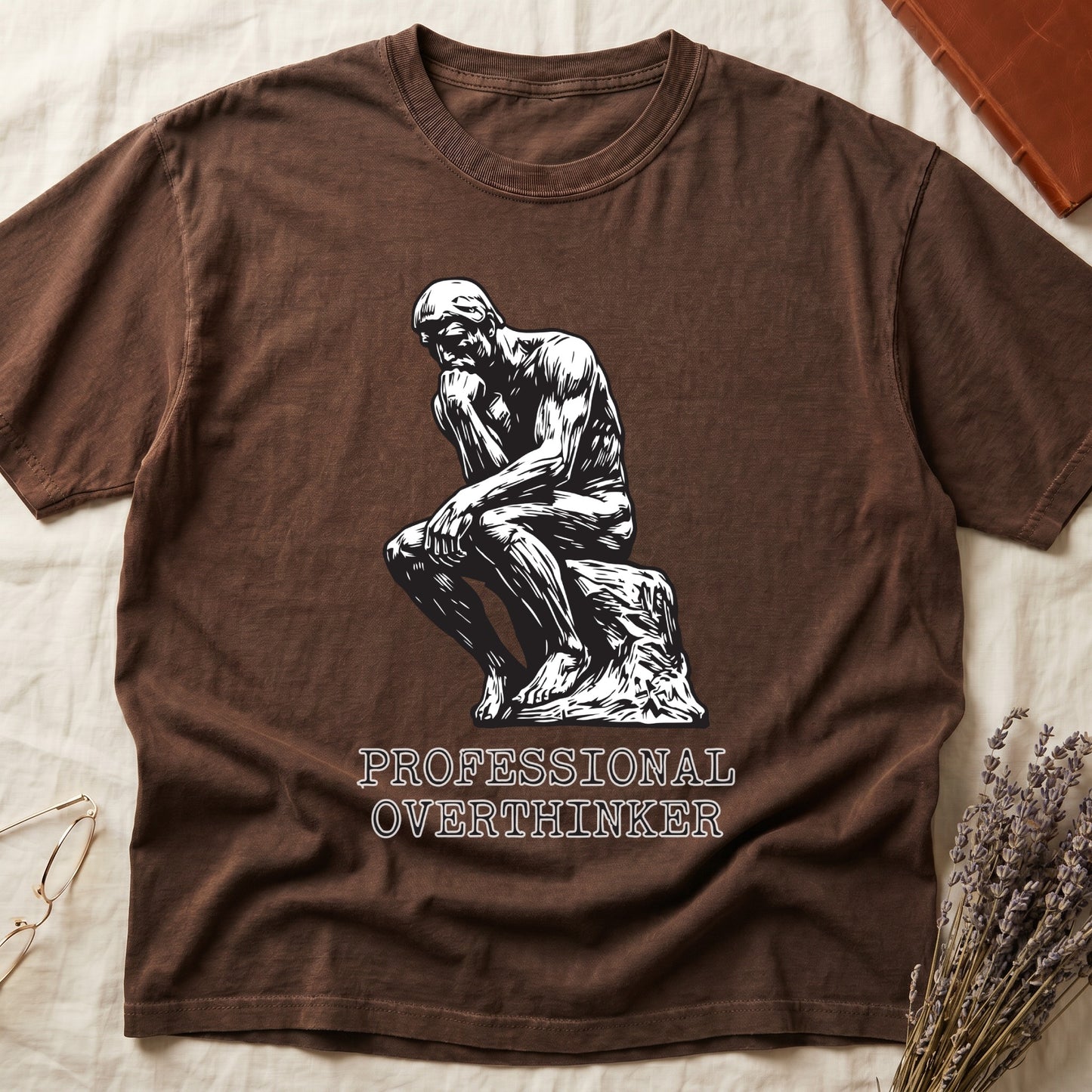 Espresso tee with monochrome rendering of Rodin's Thinker, "PROFESSIONAL OVERTHINKER" in serif capitals below.