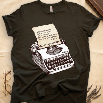 Military Green tee with vintage typewriter in cream linework, paper showing "A thing of beauty is a joy for ever" by Keats.