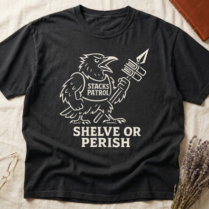 Black tee with vintage raven mascot, "STACKS PATROL" sash, feather pen aloft, "SHELVE OR PERISH" bold serif below.