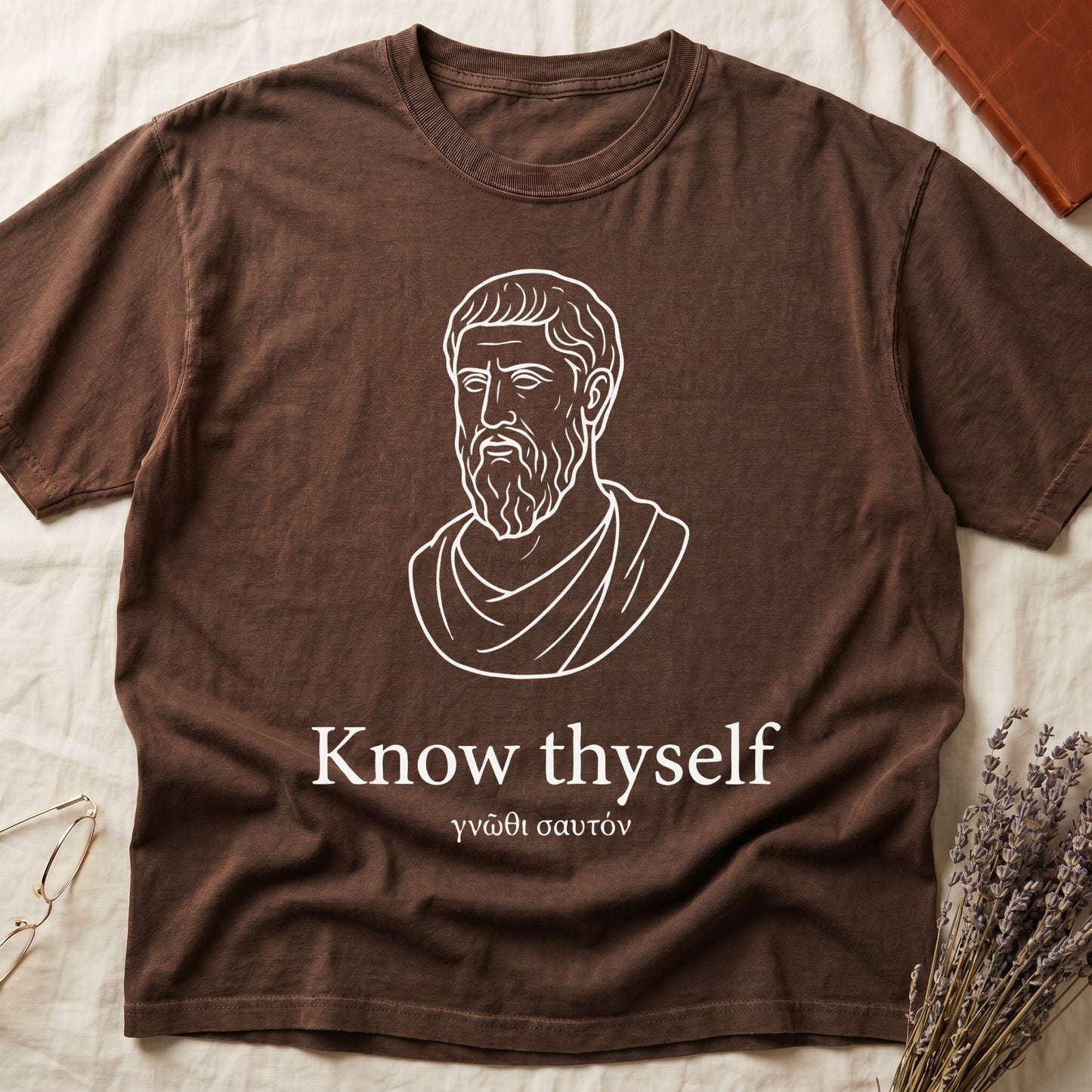 Espresso tee with classical Greek philosopher bust in white linework, "Know thyself" in cream serif below.