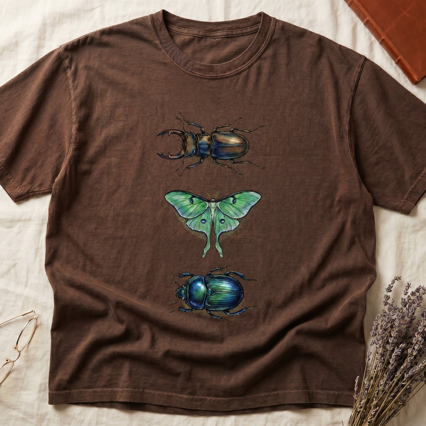 Black tee with three-panel Espresso-history plate: stag beetle, luna moth, scarab beetle in ink on yellow ground.
