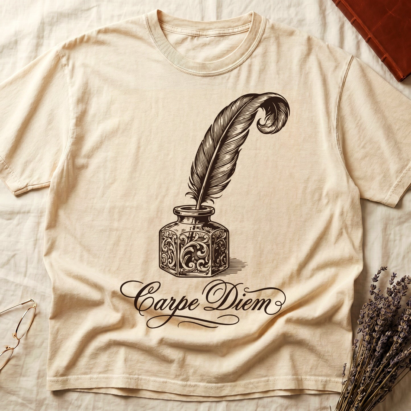 Ivory tee with ornate antique inkwell and quill pen in sepia linework, "Carpe Diem" in flowing cursive below.