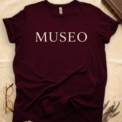 Maroon tee with "MUSEO" in oversized cream serif capitals, minimalist typographic design.