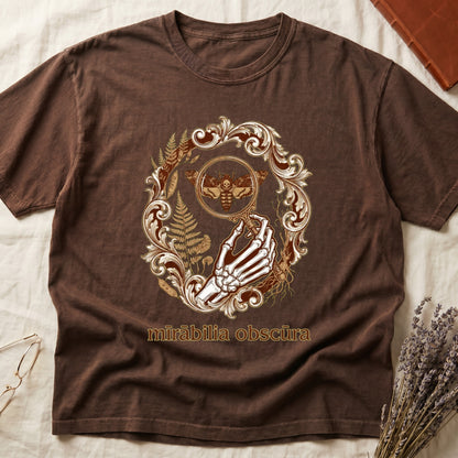 Espresso tee with skeletal hand, magnifying glass, death's-head moth, ferns on green, "mīrābilia obscūra" in Latin italic.