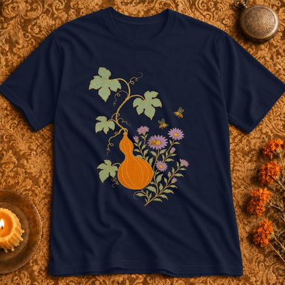 Navy t-shirt with an orange gourd, purple flowers, and bees botanical illustration.