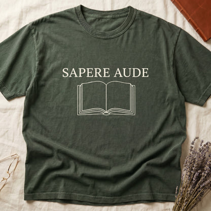 Green tee with "SAPERE AUDE" in serif capitals above a minimalist open book in cream linework.
