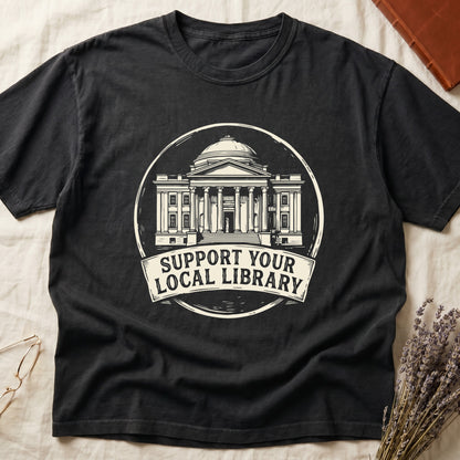 Black tee with circular cream badge of a classical library building, "SUPPORT YOUR LOCAL LIBRARY" on a banner below.