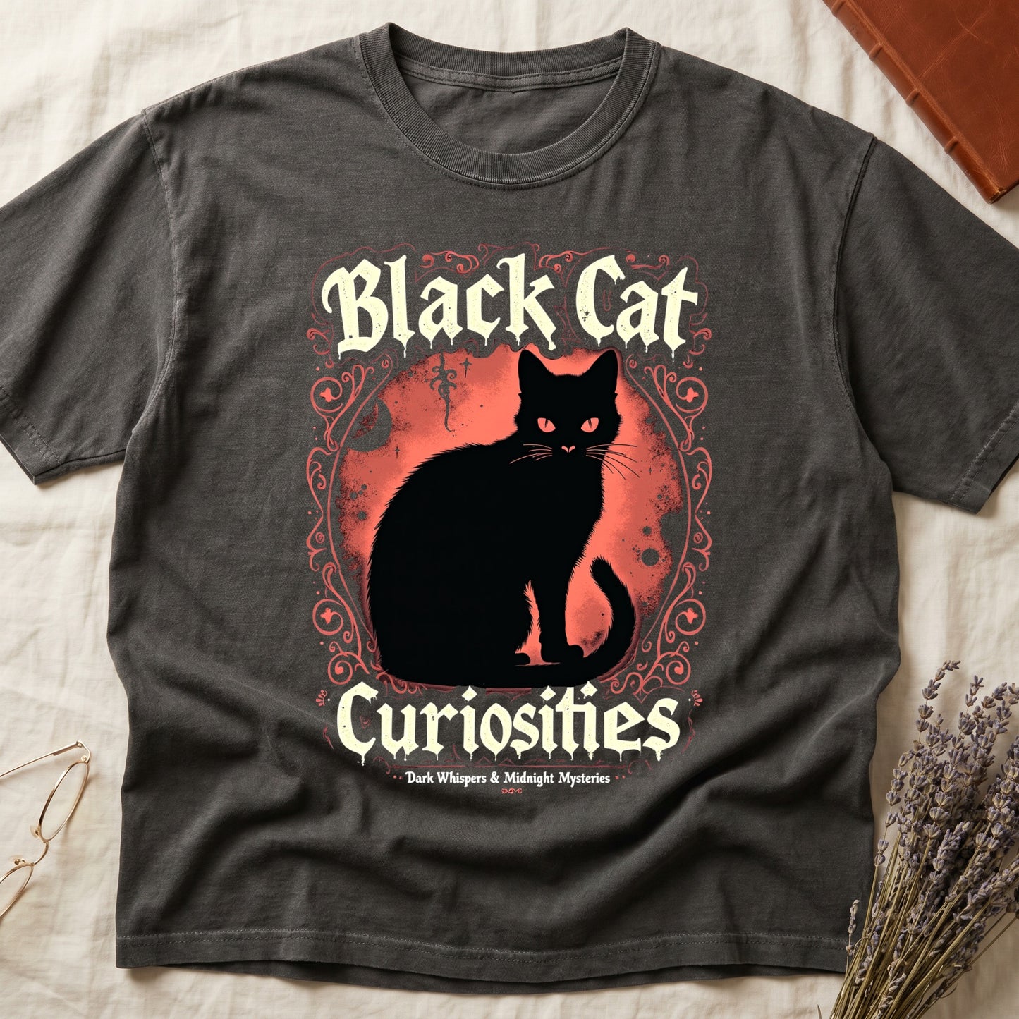 Pepper tee with black cat, red eyes, red-orange moon, "Black Cat Curiosities," "Dark Whispers & Midnight Mysteries."