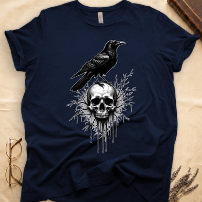 Navy tee with raven silhouette on human skull, ink drips from jaw, bare branches behind, monochrome illustration.