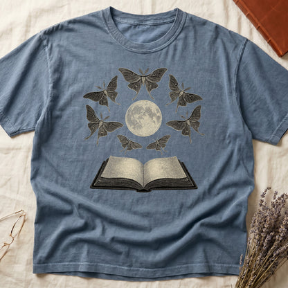Blue Jean tee with full moon center, seven luna moths in halo around, open book below, cream-on-black engraving.