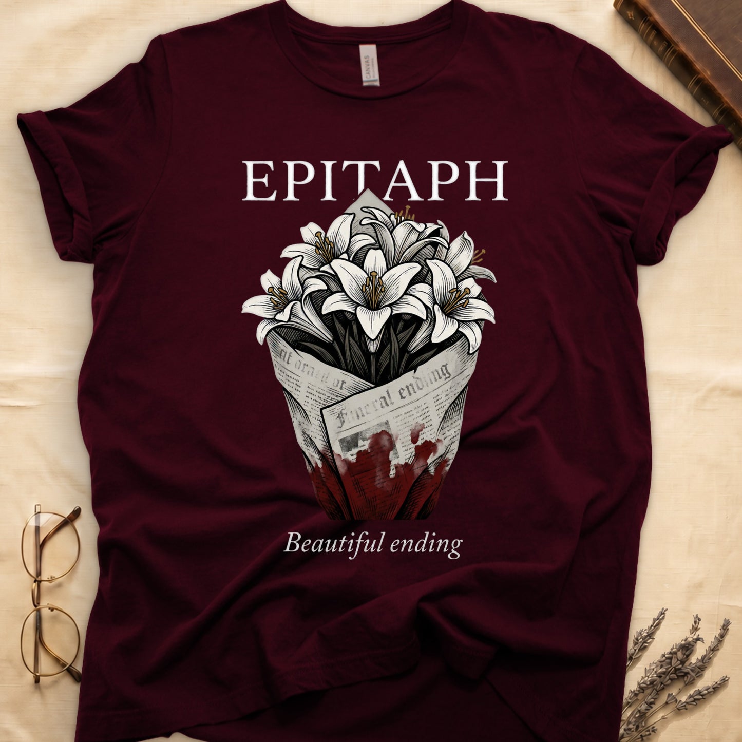 Maroon tee with "EPITAPH" over crosshatched white lilies in blood-stained newsprint wrap, "Beautiful ending" italic serif.