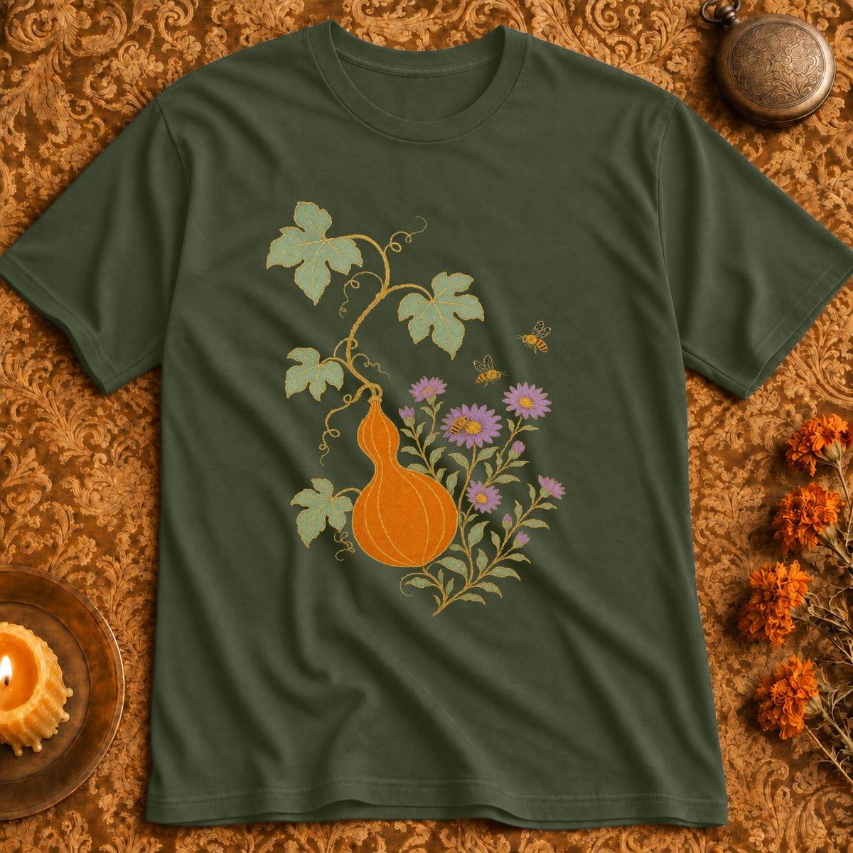 Green t-shirt with a pumpkin, purple flowers, and bees design.