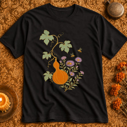 Black t-shirt with an orange gourd, purple flowers, and bees design.