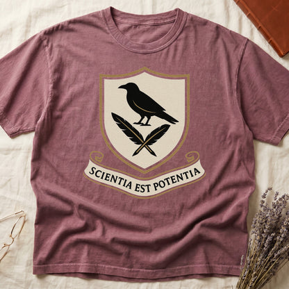 Dark Rose tee with cream-and-gold heraldic shield, black raven over crossed quills, scroll banner "SCIENTIA EST POTENTIA" below.