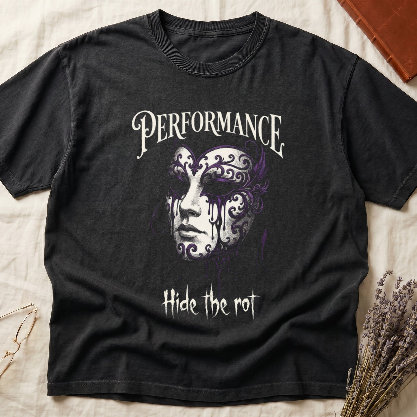 Black tee with ornate Venetian mask in cream and purple filigree dripping ink, "PERFORMANCE" top, "Hide the rot" below.
