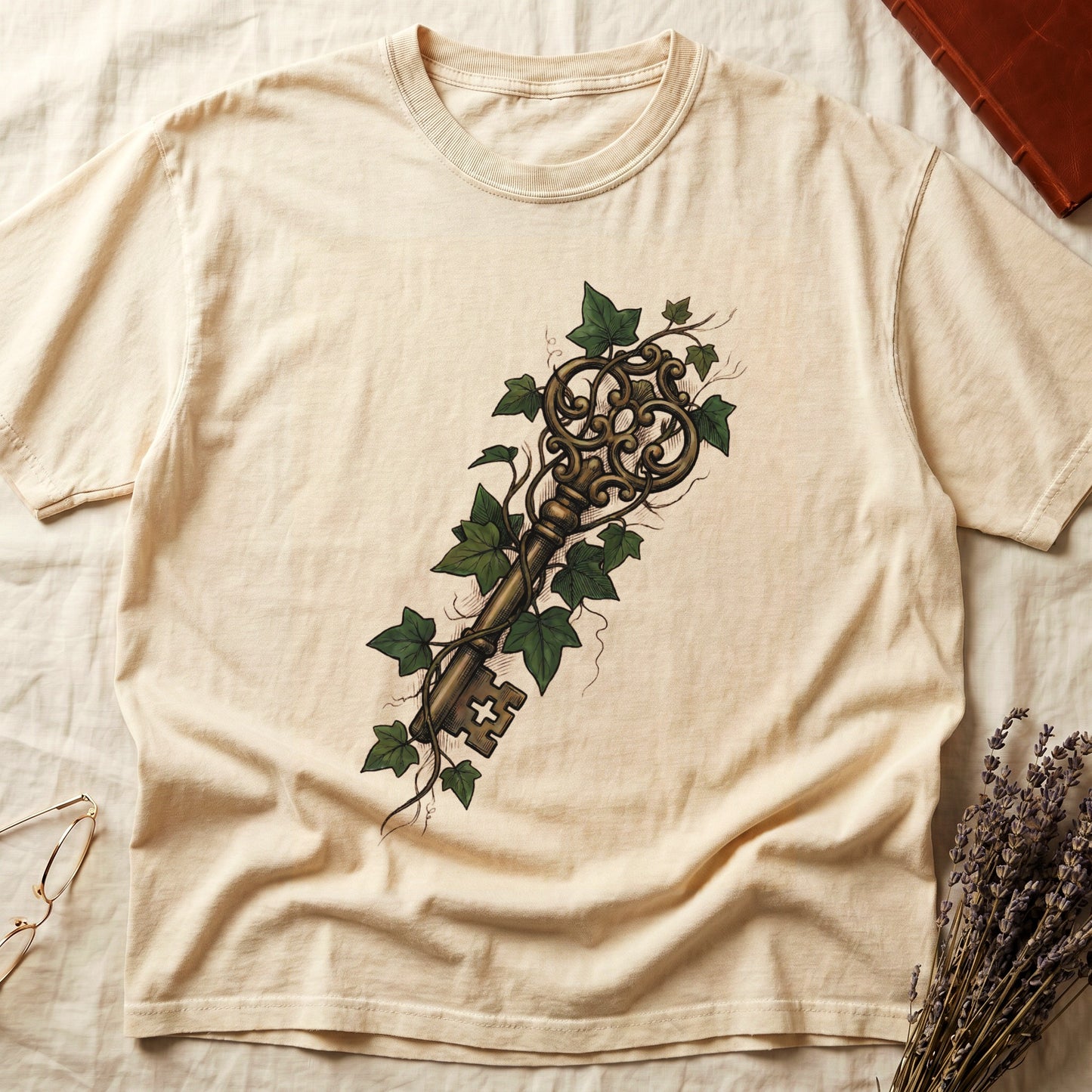 Ivory tee with ornate antique skeleton key in bronze, climbing English ivy in green on terracotta ground.