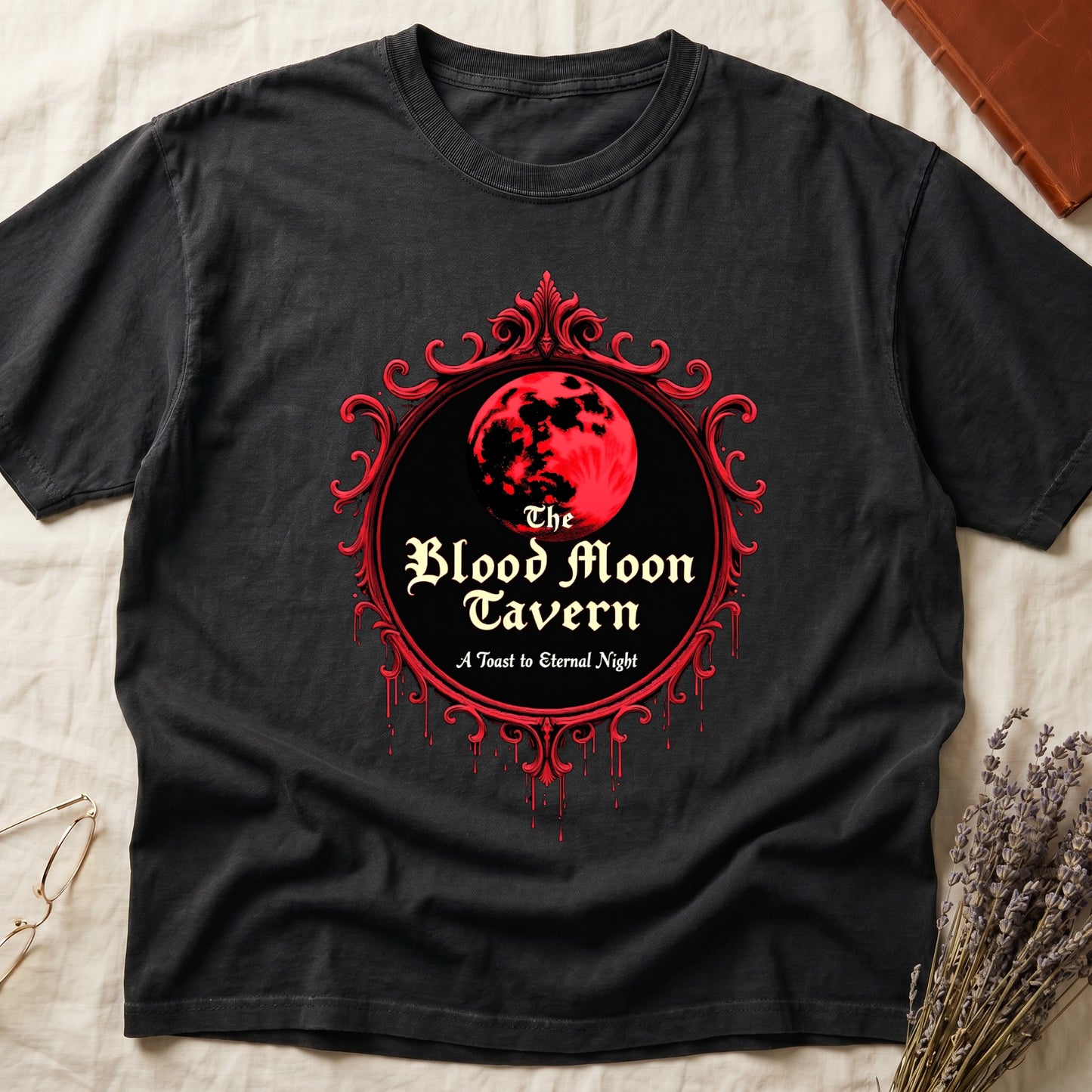 Black tee with red oval frame, blood-red moon, "The Blood Moon Tavern," "A Toast to Eternal Night," red drips below.